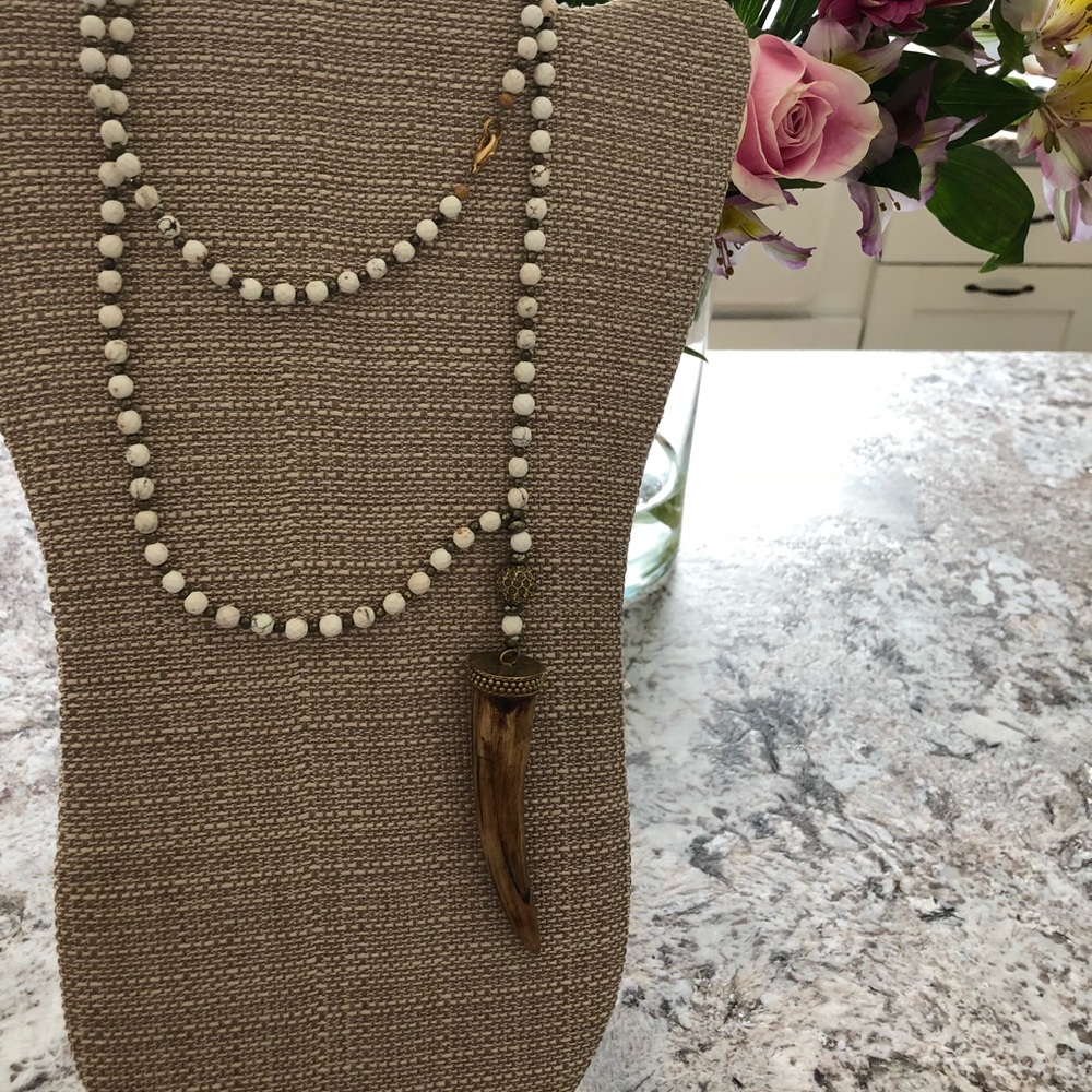 Long white beaded necklace with bone horn pendant